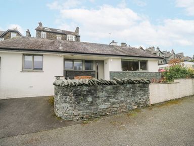 A house with a stone wall and garden at Ambwray in Ambleside