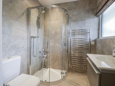 A bathroom with a shower, toilet, and sink at Ambwray in Ambleside