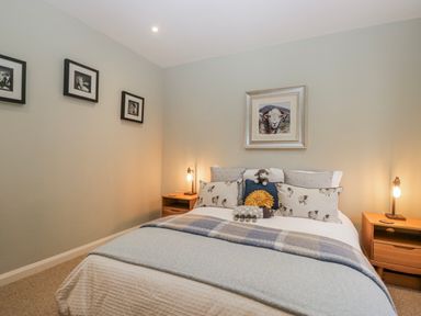 A bedroom with a bed and nightstands at Ambwray in Ambleside