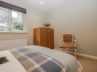 A bedroom with a bed and a flower vase at Ambwray in Ambleside