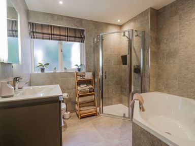 A bathroom with a shower and a bathtub at Ambwray in Ambleside