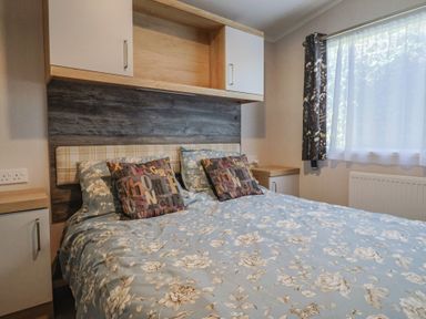 A bedroom with a double bed and bedside table at Bordeaux in Ladram Bay Otterton