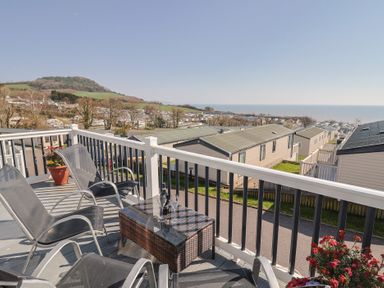 A balcony view overlooking the sea and hills at Bordeaux in Ladram Bay Otterton
