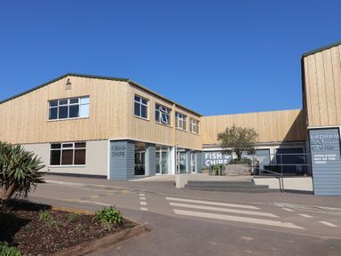 A building with a fish and chips sign at Ladram Bay Otterton