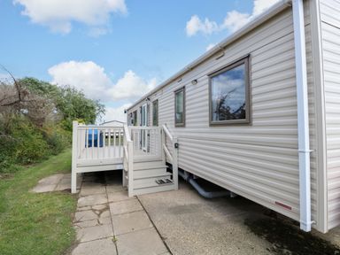 A mobile home with steps leading to a deck at PK Sunset View in Corton