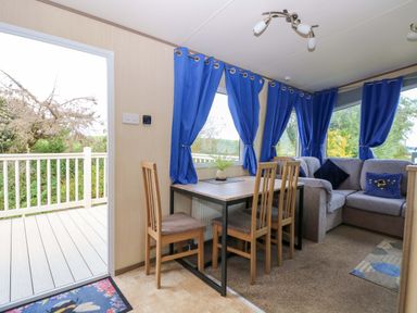 A dining area with a table and chairs at PK Sunset View in Corton