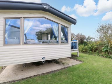 A static caravan with a deck and steps at PK Sunset View in Corton