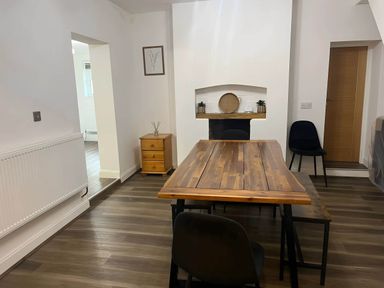 A dining room with a table and chairs at Llangollen - House - Sleeps 8- Garden in Llangollen