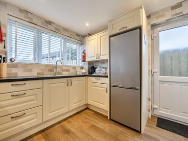 A kitchen with sink and refrigerator at 2 Bed House - Sleeps 4 - Garden - Parking - Wifi, Kendal