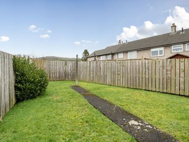 A garden with grass and a pathway at 2 Bed House - Sleeps 4 - Garden - Parking - Wifi, Kendal