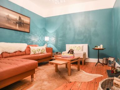 A living room with a sofa and coffee table at Rhiwlas in Rhosneigr