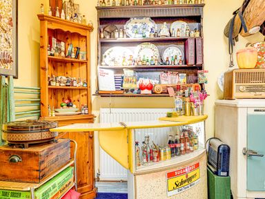 A bar area with shelves of bottles and a bar cart at Family Country Cottage with a private Valley View