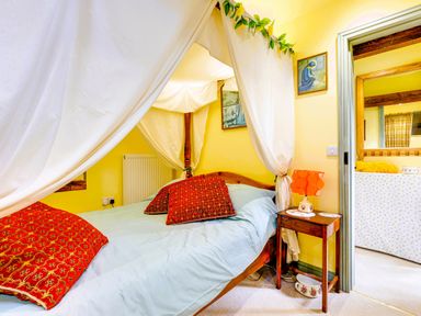A bedroom with a bed and decorative pillows at Family Country Cottage with a private Valley View