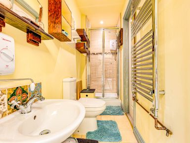 A bathroom with a sink, toilet, and shower at Family Country Cottage with a private Valley View