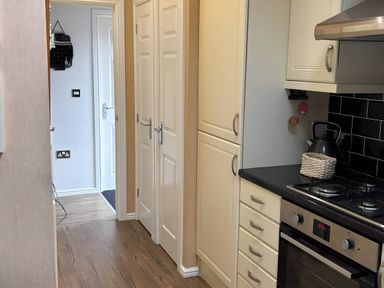 A kitchen with an oven and cabinets at 2 Bed Lodge-Sleeps 4-stunning views -Pet Friendly, Troutbeck