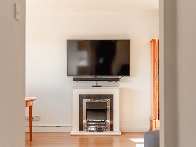 A living room with a television and fireplace at Luxury 2 Bed Room Lake View Apt Bowness Parking in Bowness-On-Windermere
