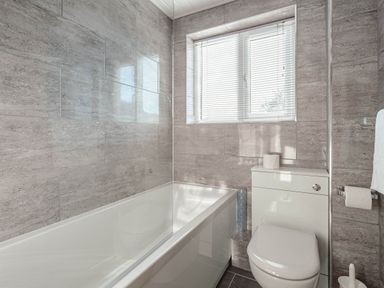 A bathroom with a bathtub and toilet at Luxury 2 Bed Room Lake View Apt Bowness Parking Bowness-On-Windermere