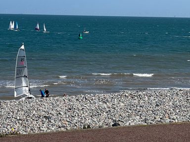 People near a sailing boat on a beach by the ocean at Sea View, East Parade Llandudno