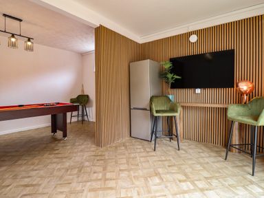 A game room with a pool table and refrigerator at Sea View, East Parade Llandudno