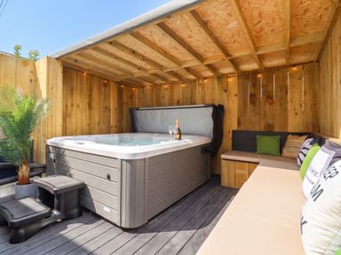 An outdoor space featuring a hot tub and seating area at Sea View, East Parade, Llandudno