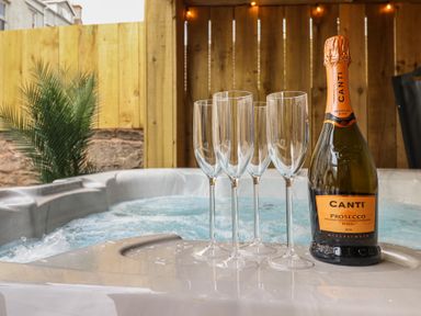 A hot tub with champagne glasses and a bottle at Sea View, East Parade Llandudno