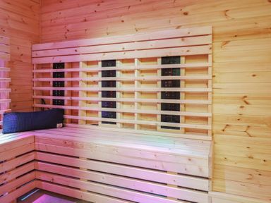 A sauna with wooden walls and heating panel at Sea View, East Parade in Llandudno