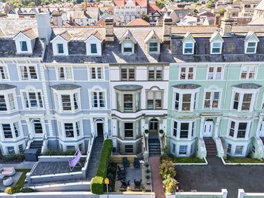 A row of terraced houses with patios at Sea View, East Parade, Llandudno
