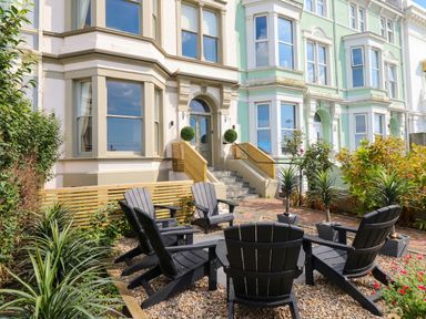 A garden with seating and plants at Sea View, East Parade, Llandudno