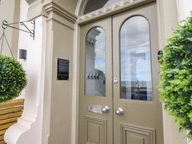 An entrance with a door and hanging plant at Sea View, Llandudno