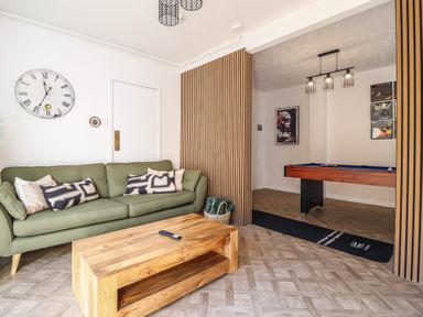 A living room with a sofa and coffee table at Sea View, East Parade Llandudno