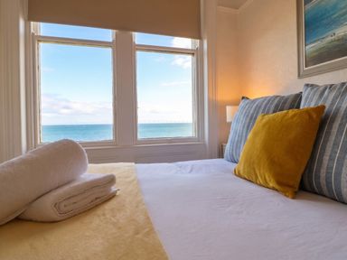A bedroom with a view of the sea at Sea View, East Parade, Llandudno