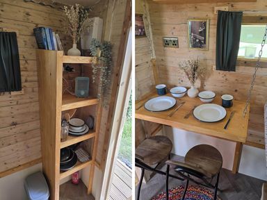 A kitchen with a table set for dining at Restored circus wagon in Saltburn-By-The-Sea
