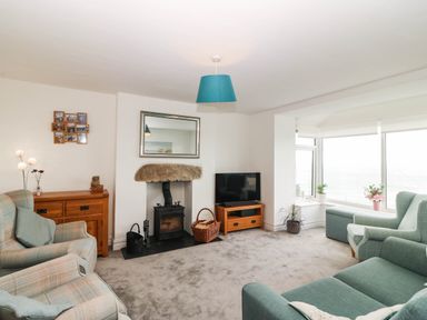 A living room with furniture and a fireplace at Briar Bank in Barmouth