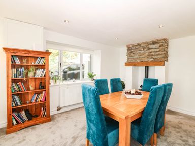 A dining room with a wooden table and chairs at Briar Bank in Barmouth