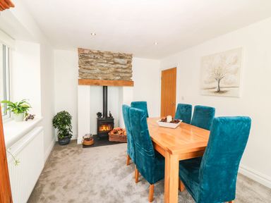 A dining room with a table and chairs at Briar Bank in Barmouth