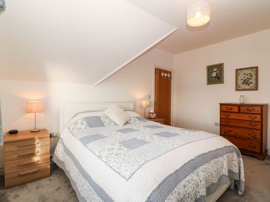 A bedroom with a bed and bedside lamp at Briar Bank in Barmouth