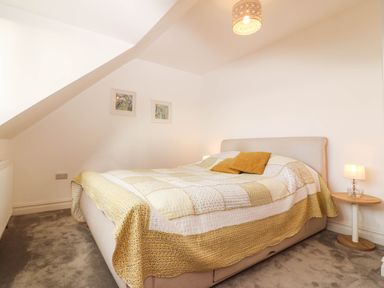 A bedroom with a bed and side table at Briar Bank in Barmouth