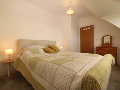 A bedroom with a bed and bedside table at Briar Bank in Barmouth