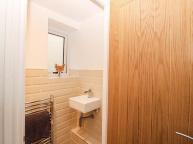 A bathroom with a sink and towel rail at Briar Bank in Barmouth