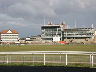A racecourse with grandstands and a fence at Blacksmiths Mews, York