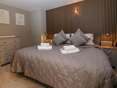 A bedroom with a double bed and decorative art at Blacksmiths Retreat in York