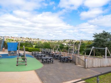 An outdoor playground with swings and climbing frame at Static Caravan Hoburne Devon Bay in Paignton