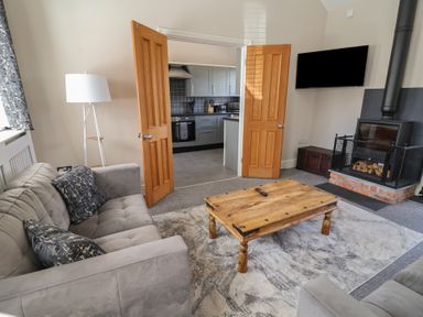 A living room with a sofa and a coffee table at Elwy Cottage St Asaph