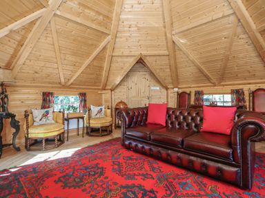 A living room with a sofa and armchairs at Antlers Lodge in Biddulph Moor