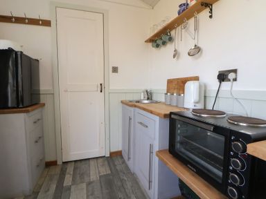 A kitchen with a sink and an oven at Shepherds Delight in Biddulph Moor
