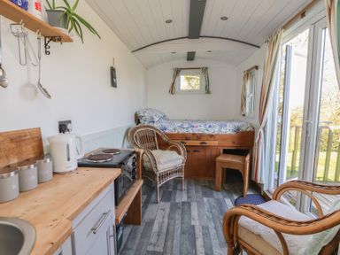 A living room with a bed and furniture at Shepherds Delight in Biddulph Moor