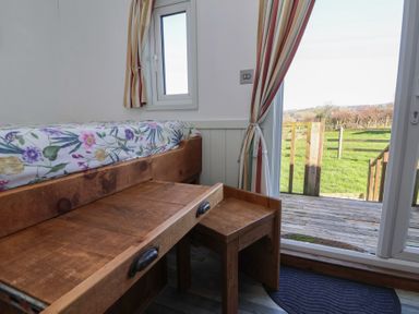 A bedroom with a bed and drawer at Shepherds Delight in Biddulph Moor