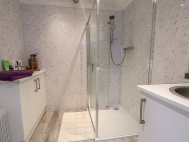 A shower and sink in a bathroom at Shepherds Delight in Biddulph Moor