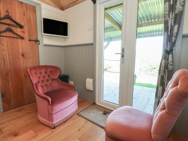 A seating area with chairs and door at Golden Fleece in Biddulph Moor
