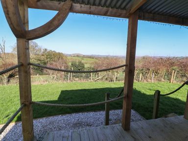 An outdoor area with a wooden structure and a view of the lawn at Golden Fleece in Biddulph Moor